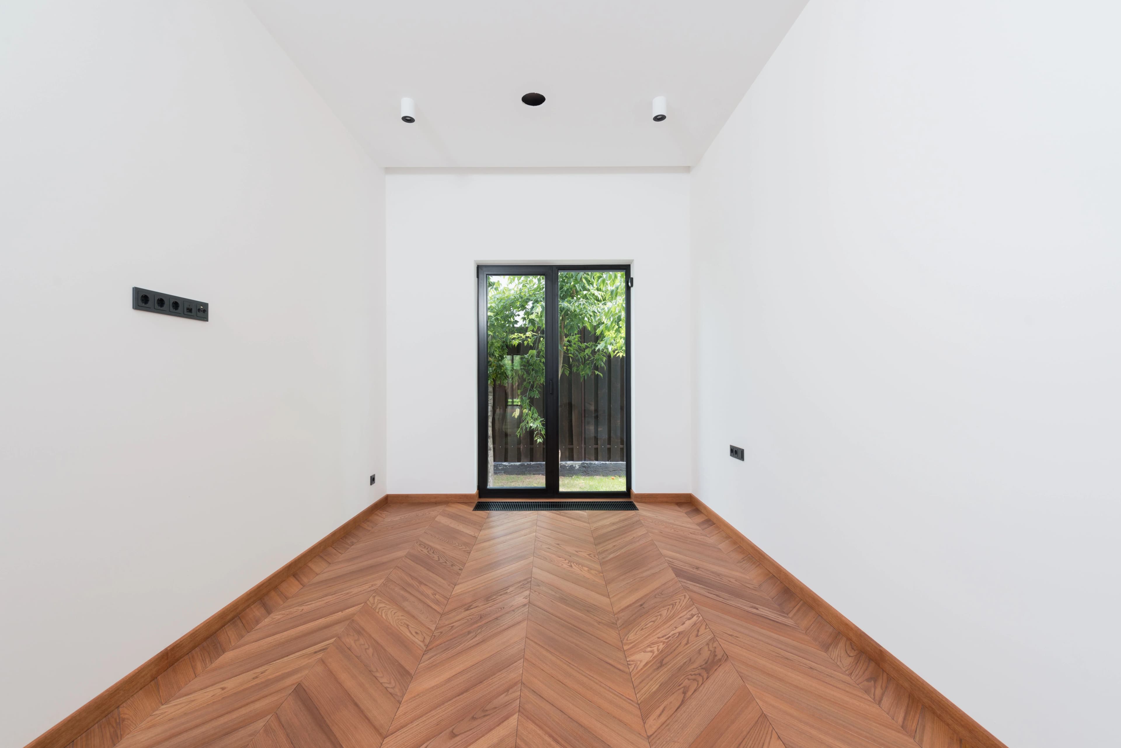 Pièce vide au parquet refait après travaux